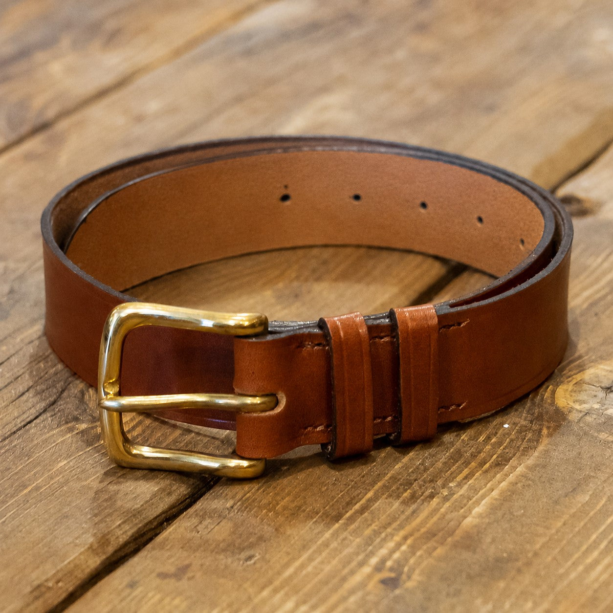 Meccanica Alderley tan Leather  belt with cast brass buckle in a roll