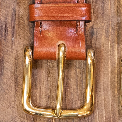 brass buckle detail on leather belt